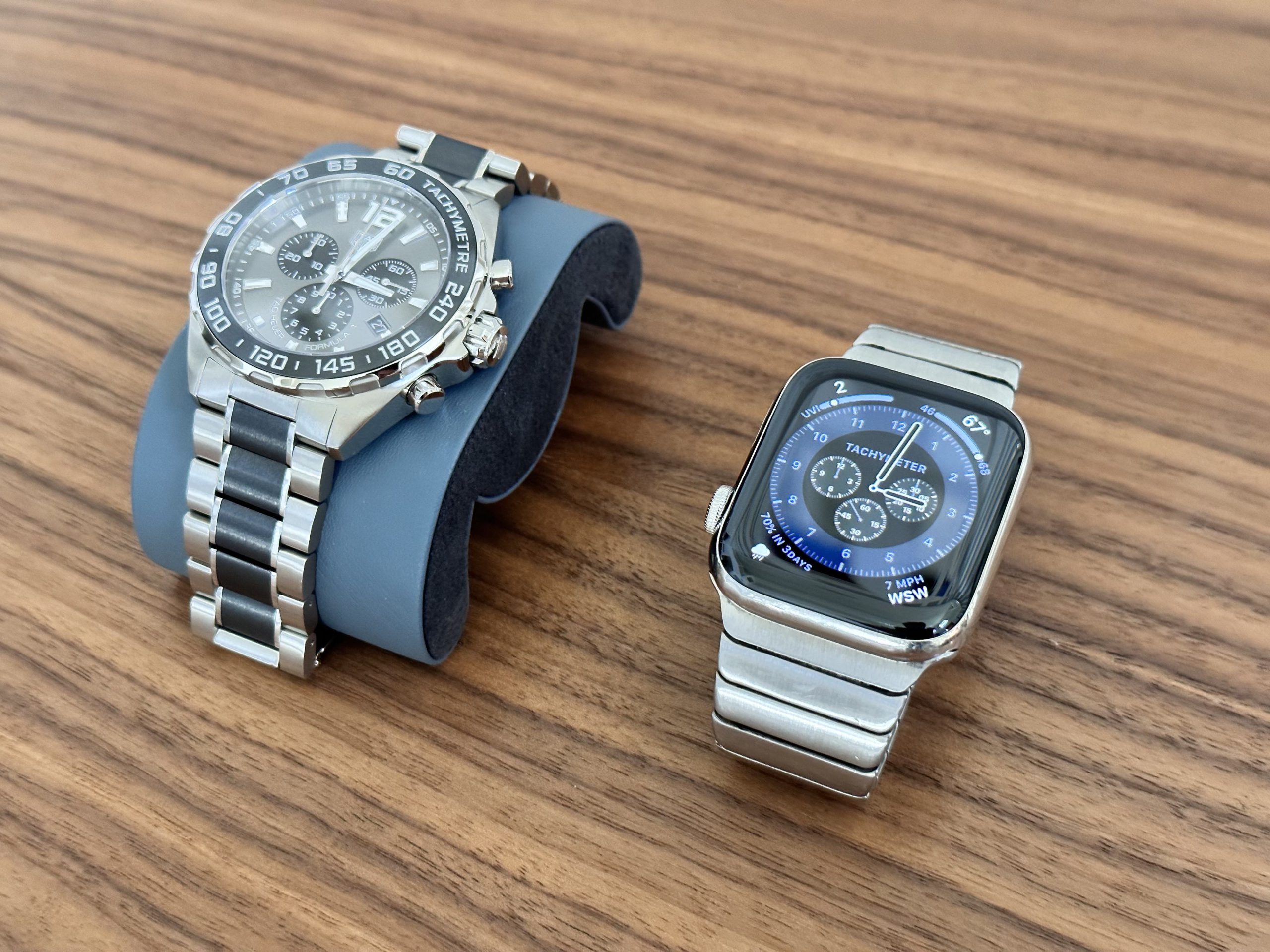 A traditional wristwatch next to an Apple Watch